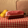 pink and willow pencil case on sofa with lemons